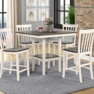 A dining room table with chairs and a rug.