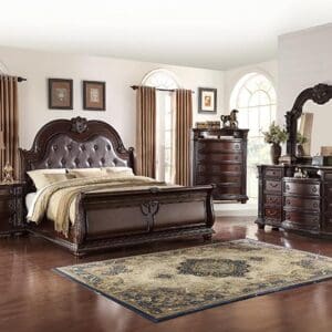 A bedroom with a bed, dresser and night stand.