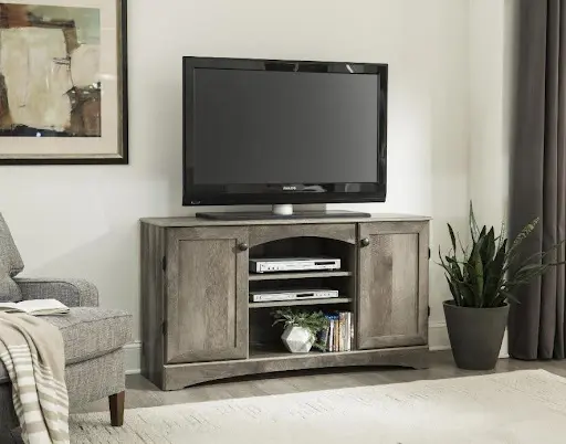 A tv stand with a television on top of it.