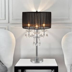 A table lamp sitting on top of a white table.